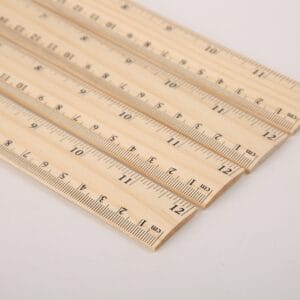 AUTO-DRAFT: Close-up of multiple wooden rulers showing centimeter markings for precise measurement.