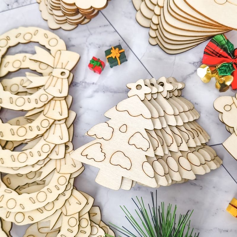 Colorful DIY Wooden Christmas Tree Ornaments: Bulk pack of unfinished wooden Christmas tree ornaments, ready for painting and crafting.