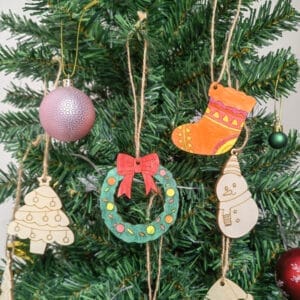 Colorful DIY wooden Christmas tree ornaments: Set of hand-painted wooden Christmas ornaments including a stocking, wreath, snowman, and tree.