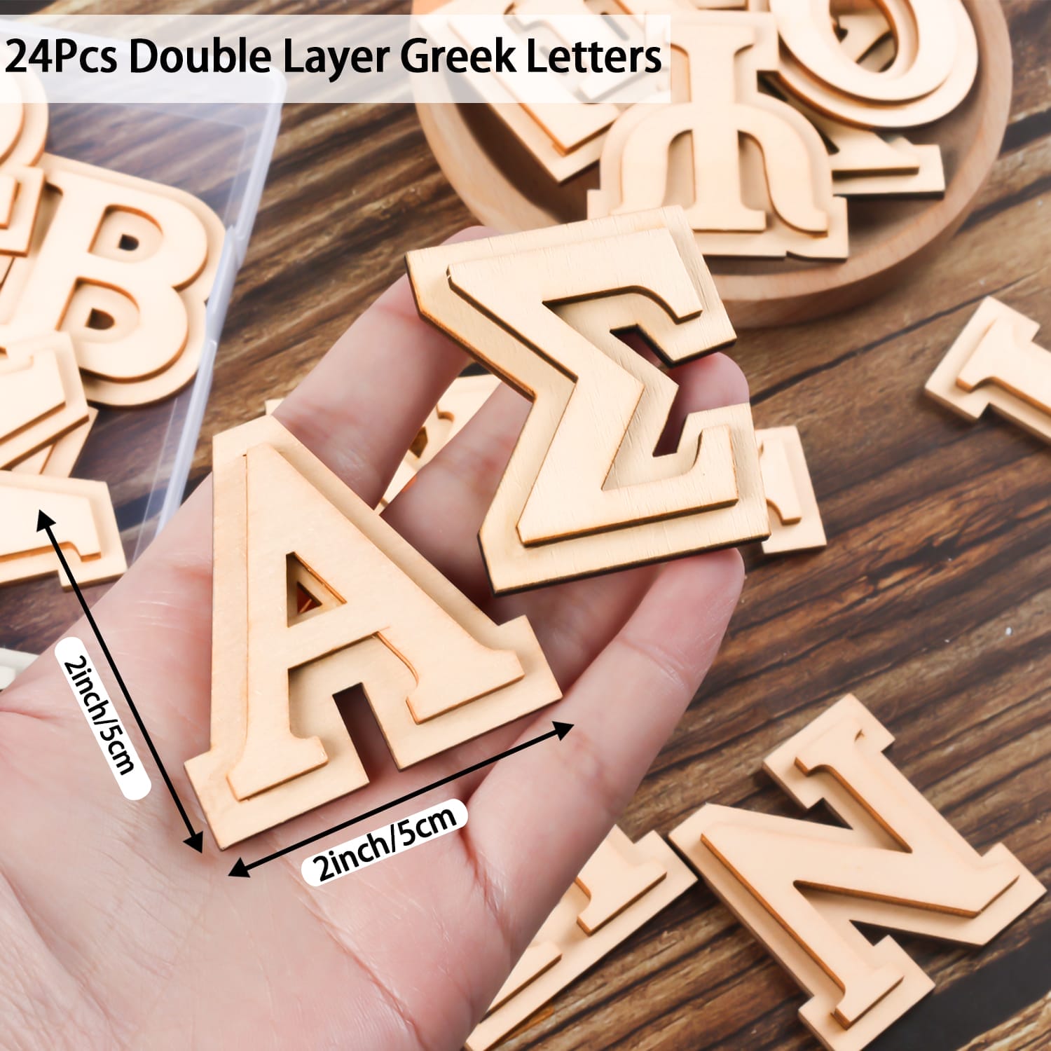 A hand holds two wooden Greek letters, Alpha and Sigma, each about 2 inches, with more wooden Greek letters and a labeled bag nearby. The text reads “24Pcs Double Layer Greek Letters.”.