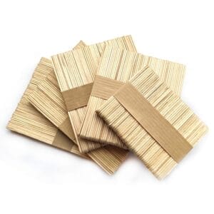Bundles of Wood Sticks For Crafts are stacked neatly with paper bands around the center, arranged on a white background.