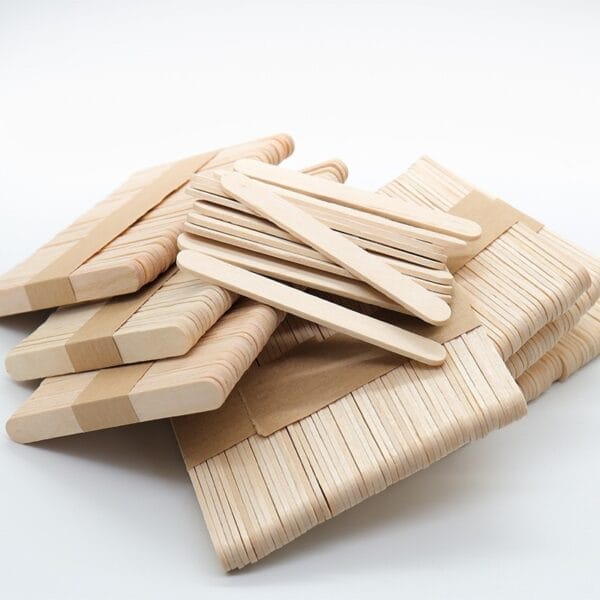 Several bundles of Wood Sticks For Crafts and popsicle sticks are stacked together on a white background.