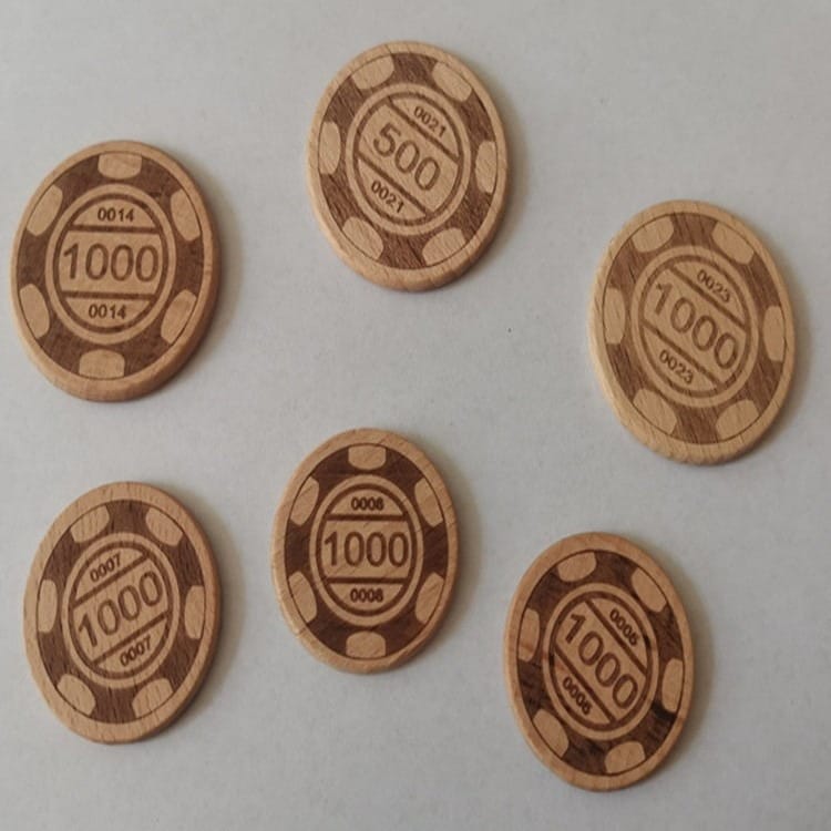Six wooden poker chips, crafted as beech wood coins, are arranged on a white surface; four display "1000", one shows "500", and one displays "100".