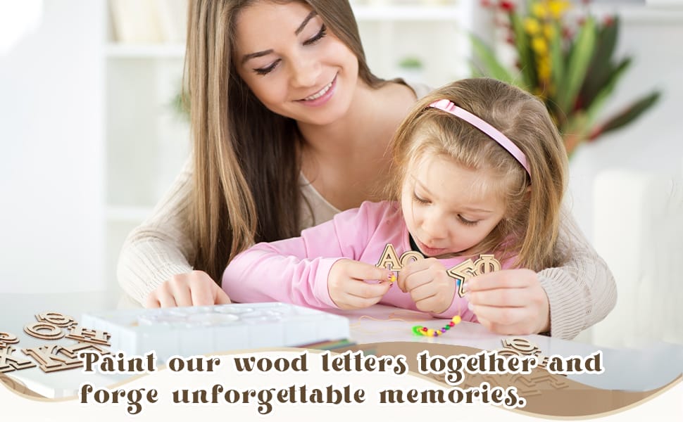 An adult and a child paint wooden Greek letters and string beads at a table; text reads, “Paint our wood letters together and forge unforgettable memories.”.