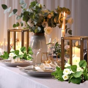 Elegant wooden candle stands with candles & floral decor on a wedding table. Wholesale wood candle stand supplier.