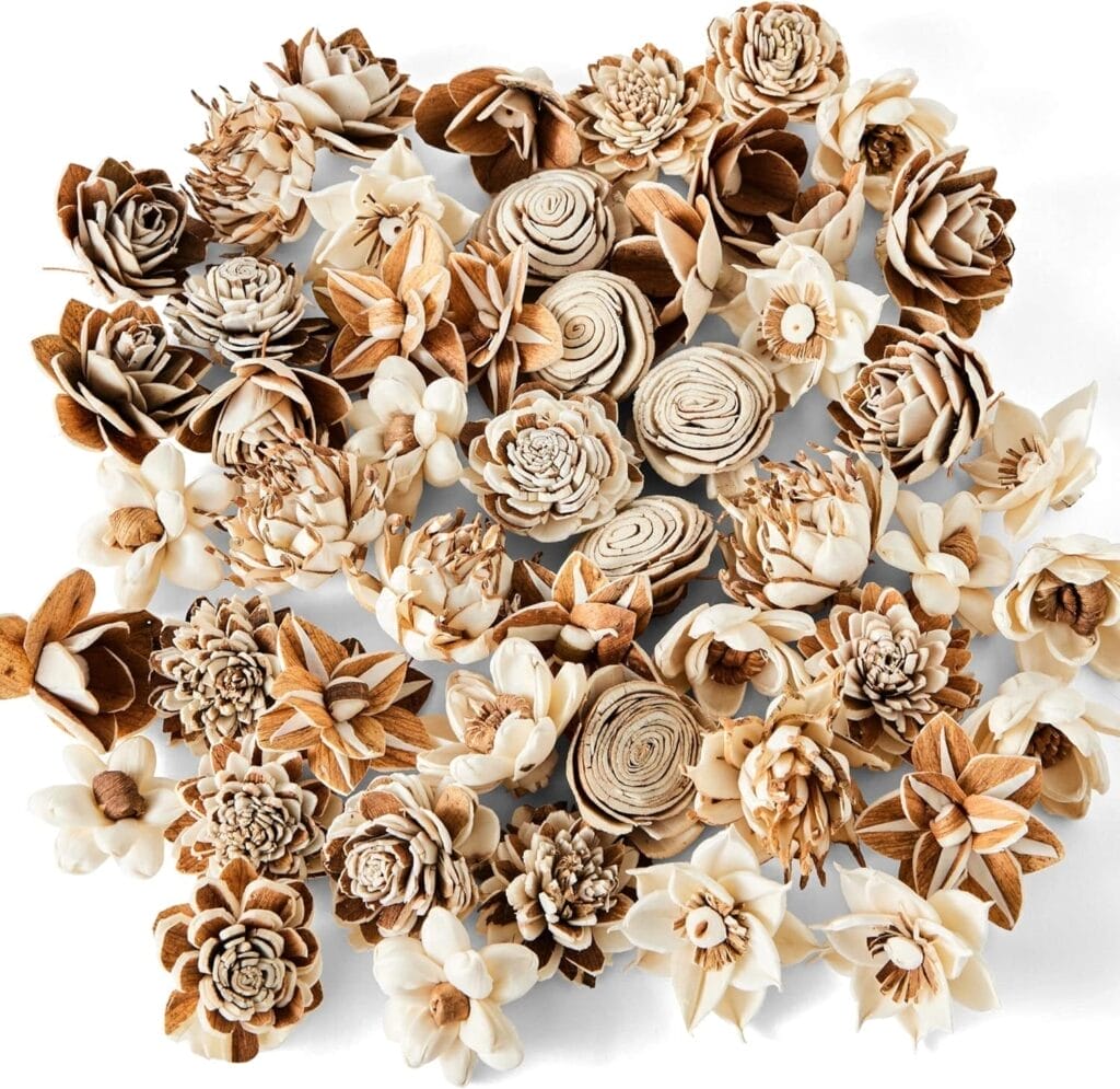 An assortment of intricately crafted, natural-colored Sola Wood Flowers arranged closely together on a white background.