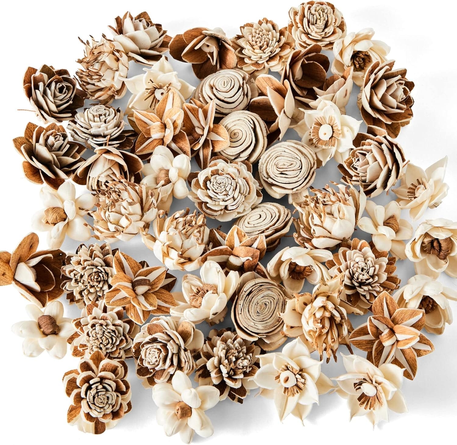 An assortment of intricately crafted, natural-colored Sola Wood Flowers arranged closely together on a white background.