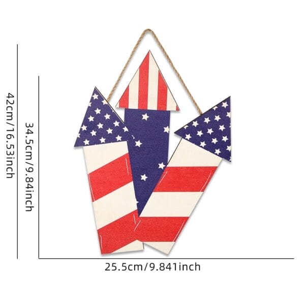 Wooden American flag wall decor shaped like three rockets, showcasing patriotic colors. The centerpiece rocket stands 34.5 cm tall, with overall dimensions of 42 cm in height and 25.5 cm wide—perfect for adding a bold touch to any room.