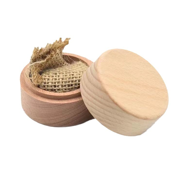 Round wooden container with a detached lid, showing a piece of burlap fabric inside, set against a white background.