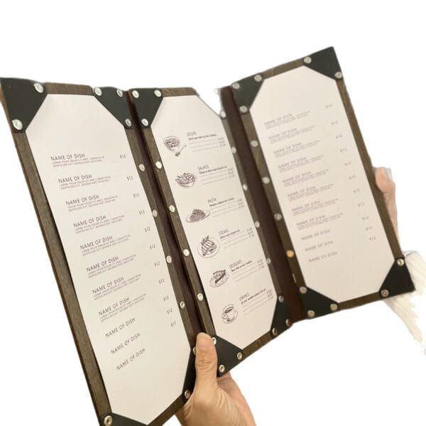 Hands holding open wooden restaurant menu with prices. Wholesale foldable menu covers.