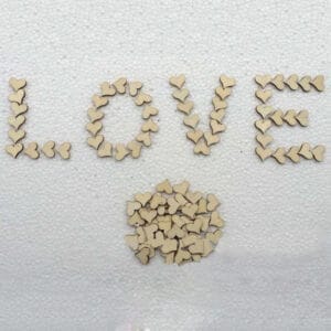 Wooden hearts arranged to spell "LOVE," with extra hearts below. Great for crafts and decorations.