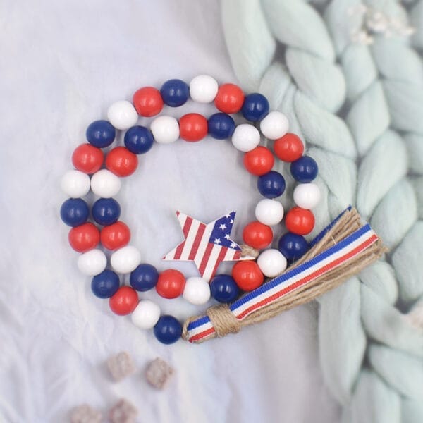 Patriotic wooden beads garland with star charm. Red, white, and blue wooden beads.