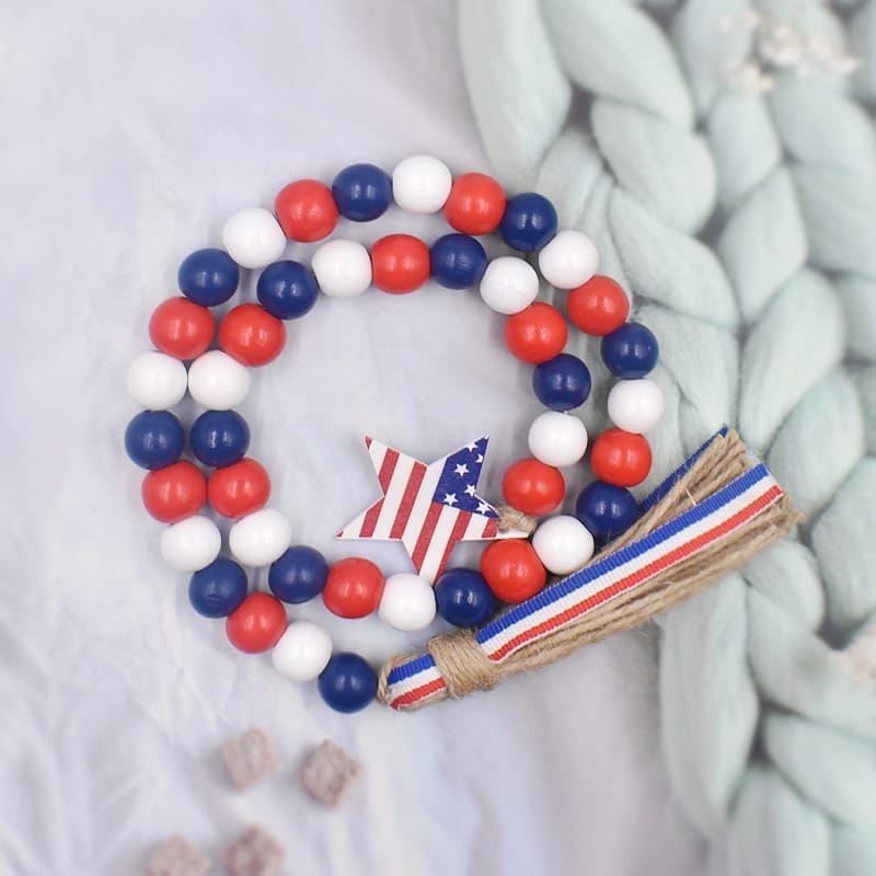 Patriotic wooden beads garland with star charm. Red, white, and blue wooden beads.