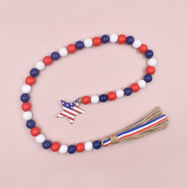 Patriotic beaded garland with wooden star and burlap tassel. Red, white, and blue wooden beads.