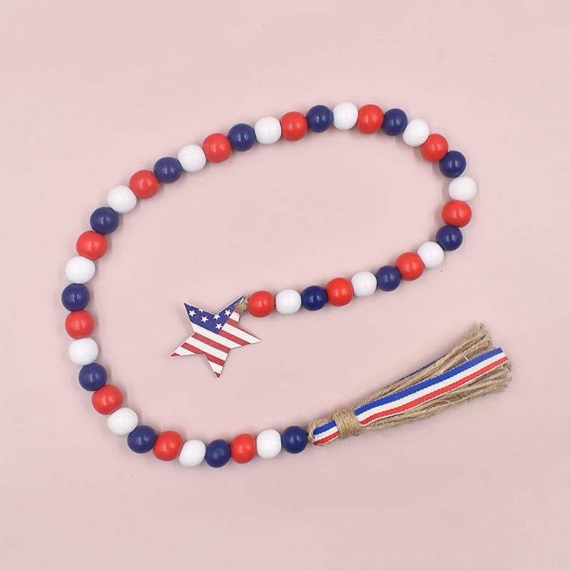 Patriotic beaded garland with wooden star and burlap tassel. Red, white, and blue wooden beads.