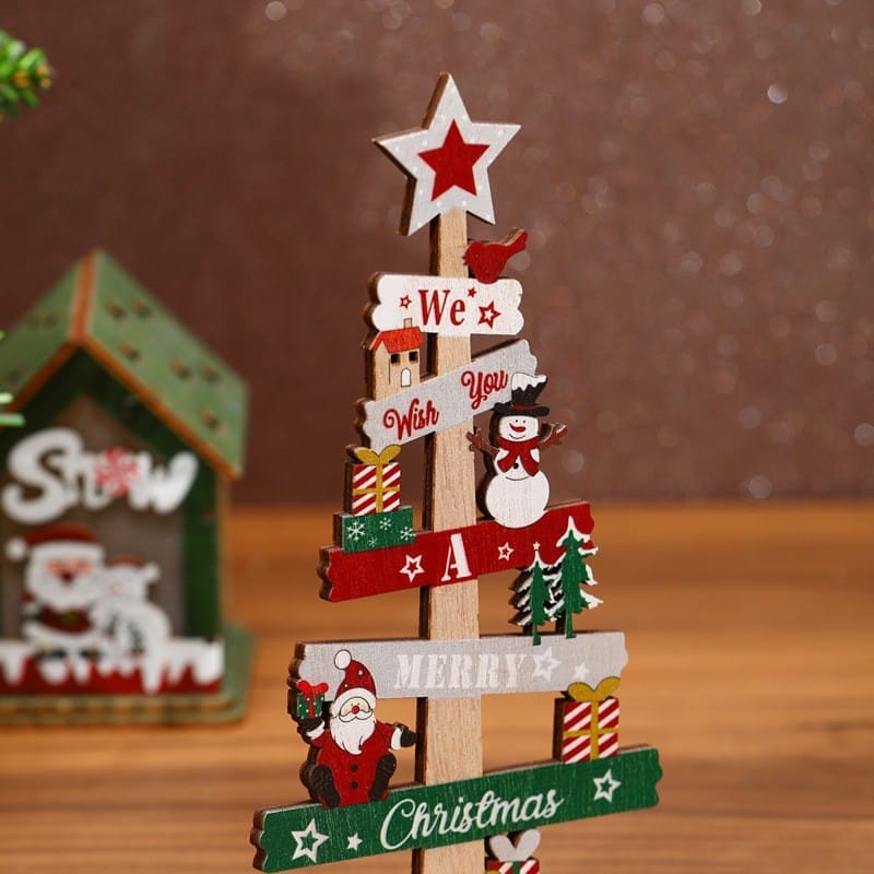 A charming Christmas wooden ornament featuring festive decorations, a snowman, presents, and "We Wish You A Merry Christmas" on planks—perfect as Christmas tree decorations or for bulk orders from a wholesale manufacturer.
