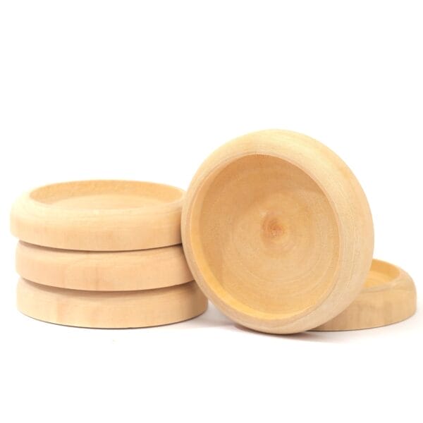 A stack of light wooden coasters, with one coaster leaning against the stack, all on a white background—an eco-friendly touch for your tabletop.