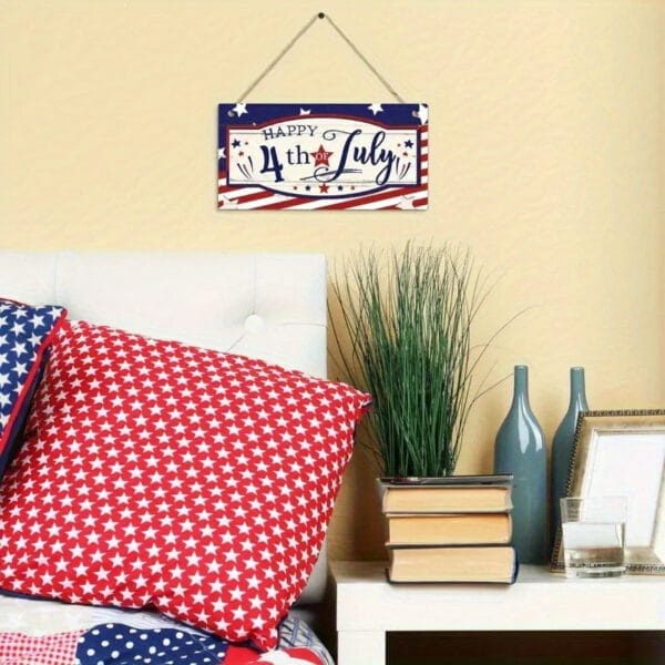 Happy 4th of July wood sign hanging above a bed with patriotic bedding. Eco-friendly wooden wall decor.