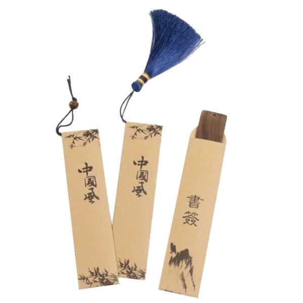 Three traditional Chinese bookmarks in vintage Chinese style, crafted from paper and wood, feature elegant calligraphy—one with a blue tassel—and showcase the charm of custom wood crafts.
