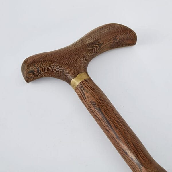A close-up view of a Red Sandalwood Cane with a T-shaped handle and a brass collar, set against a plain white background—perfect for those seeking quality from a reliable wholesale supplier.