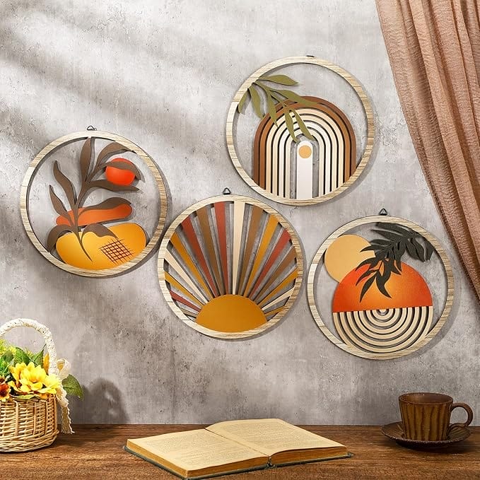 Four 10 Inch round Boho Wall Art pieces with abstract orange, yellow, and brown designs hang above a table with an open book, a cup, and a basket of yellow flowers. Brown curtain on the right.