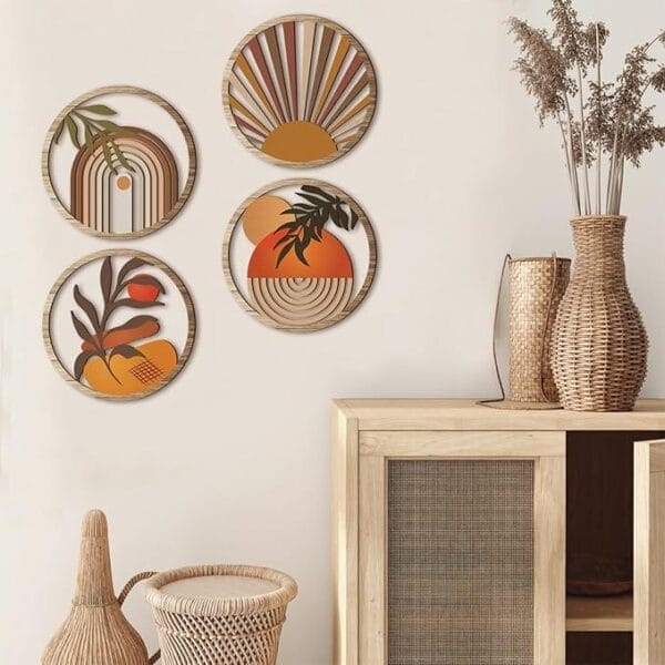 Four round, abstract Boho wall art pieces in earth tones hang above a light wood cabinet with wicker accents and dried plants in woven baskets and vases.