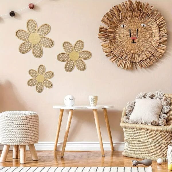 A cozy room with woven decor, wall wood decor accents, a lion wall hanging, three flower wall accents, a round textured stool, a small table with mugs, and a cushioned chair with pillows.