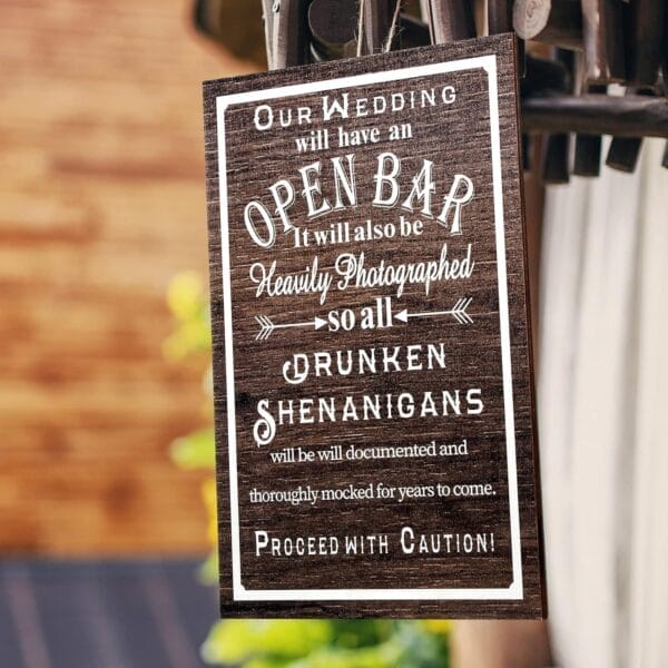 Rustic wooden wedding sign: "Our Wedding will have an Open Bar. Drunken Shenanigans will be documented. Proceed with Caution!