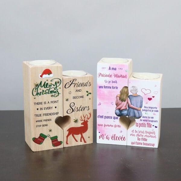 Three decorative wood candle holders with holiday and sentimental messages in English and French, featuring heart cutouts and illustrated designs.