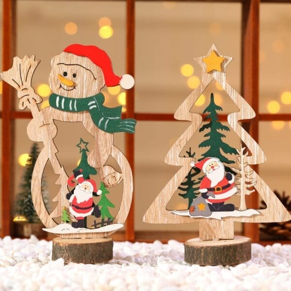 Two wood Christmas decorations—one a snowman with Santa inside, another a tree with Santa—rest on a snowy surface with lights twinkling behind. Perfect as custom Christmas ornaments to add festive charm to your holiday décor.
