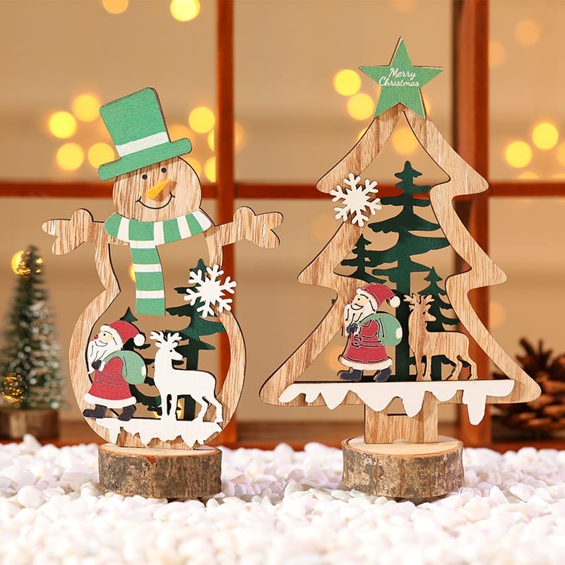 Wood Christmas decoration featuring a snowman and tree with cutout designs of Santa, reindeer, and snowflakes—displayed on white pebbles with warm lights. Perfect for custom orders or ornaments wholesale.
