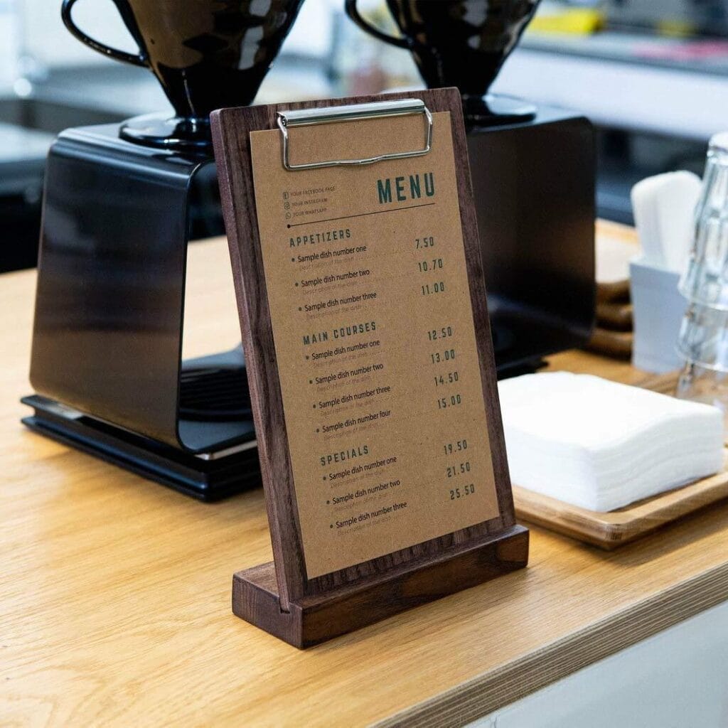 Wood clipboard stand holding A4 menu on a wooden counter