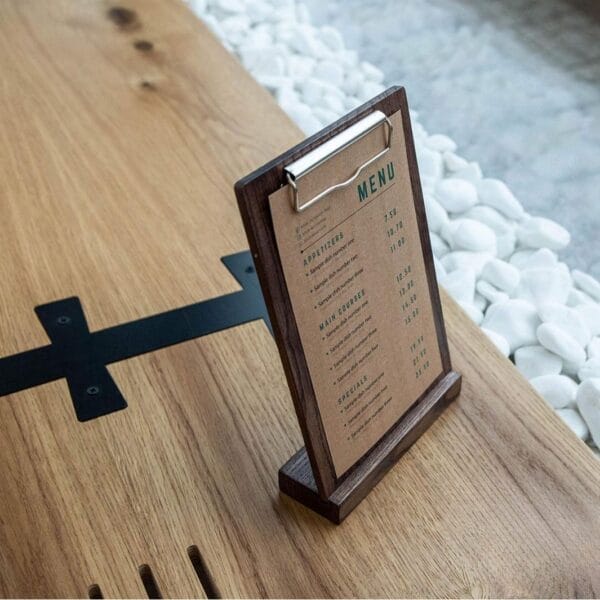 Wooden A4 menu holder with price list on a table. Wholesale wood clipboard stand.