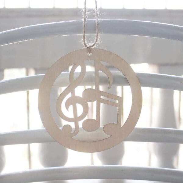 Wooden music note ornament hanging from twine. Eco-friendly wood craft.