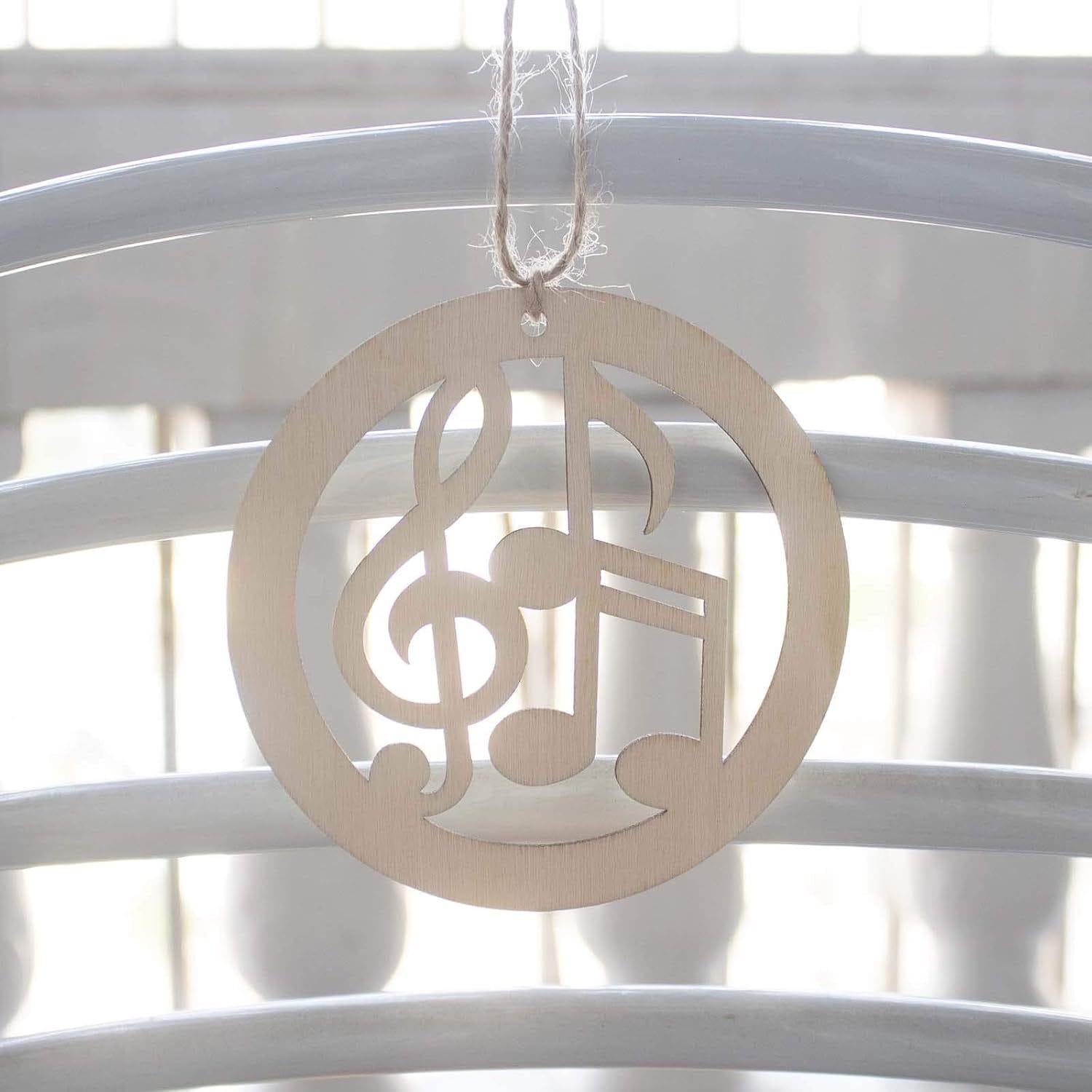 Wooden music note ornament hanging from twine. Eco-friendly wood craft.
