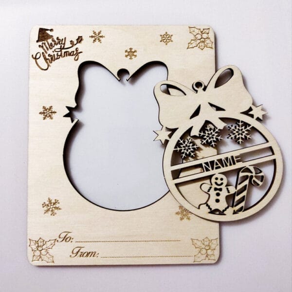 Laser-cut wooden Christmas photo frame crafted from eco-friendly wood craft pieces, featuring festive decorations, a blank name tag, and fields for "To" and "From" at the bottom.