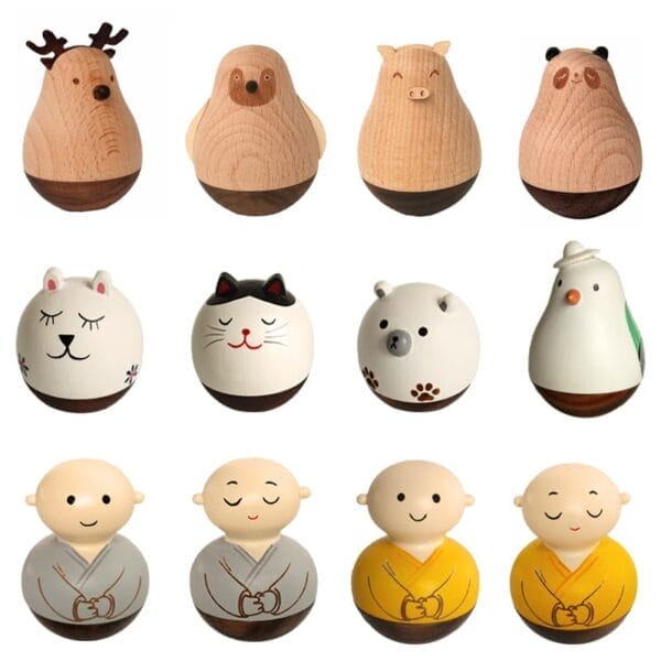 Twelve wooden figurines, crafted in the style of wood crafts, are shaped and painted as various animals and monks, arranged in three rows against a white background.