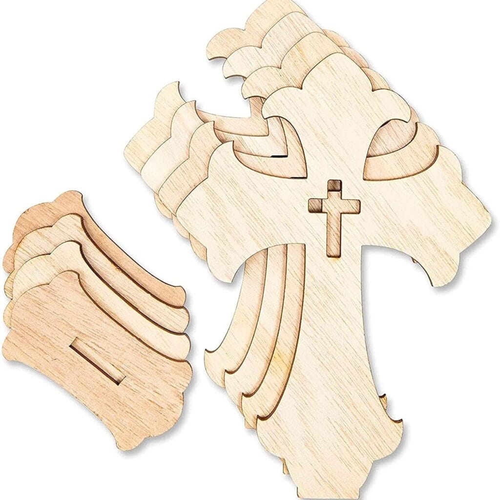 Several unfinished wood cross shapes are stacked together, with additional loose wooden pieces nearby. Each cross has a smaller cross cutout in the center, ideal for wood cross craft projects or as a handmade decorative set.