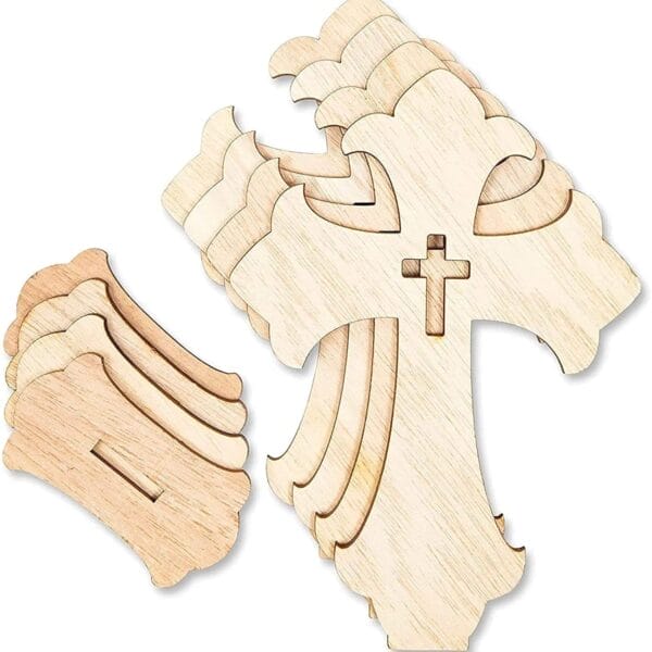 Several unfinished wood cross shapes are stacked together, with additional loose wooden pieces nearby. Each cross has a smaller cross cutout in the center, ideal for wood cross craft projects or as a handmade decorative set.