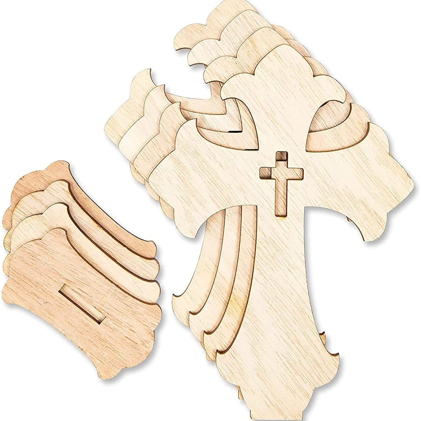 Several unfinished wood cross shapes are stacked together, with additional loose wooden pieces nearby. Each cross has a smaller cross cutout in the center, ideal for wood cross craft projects or as a handmade decorative set.