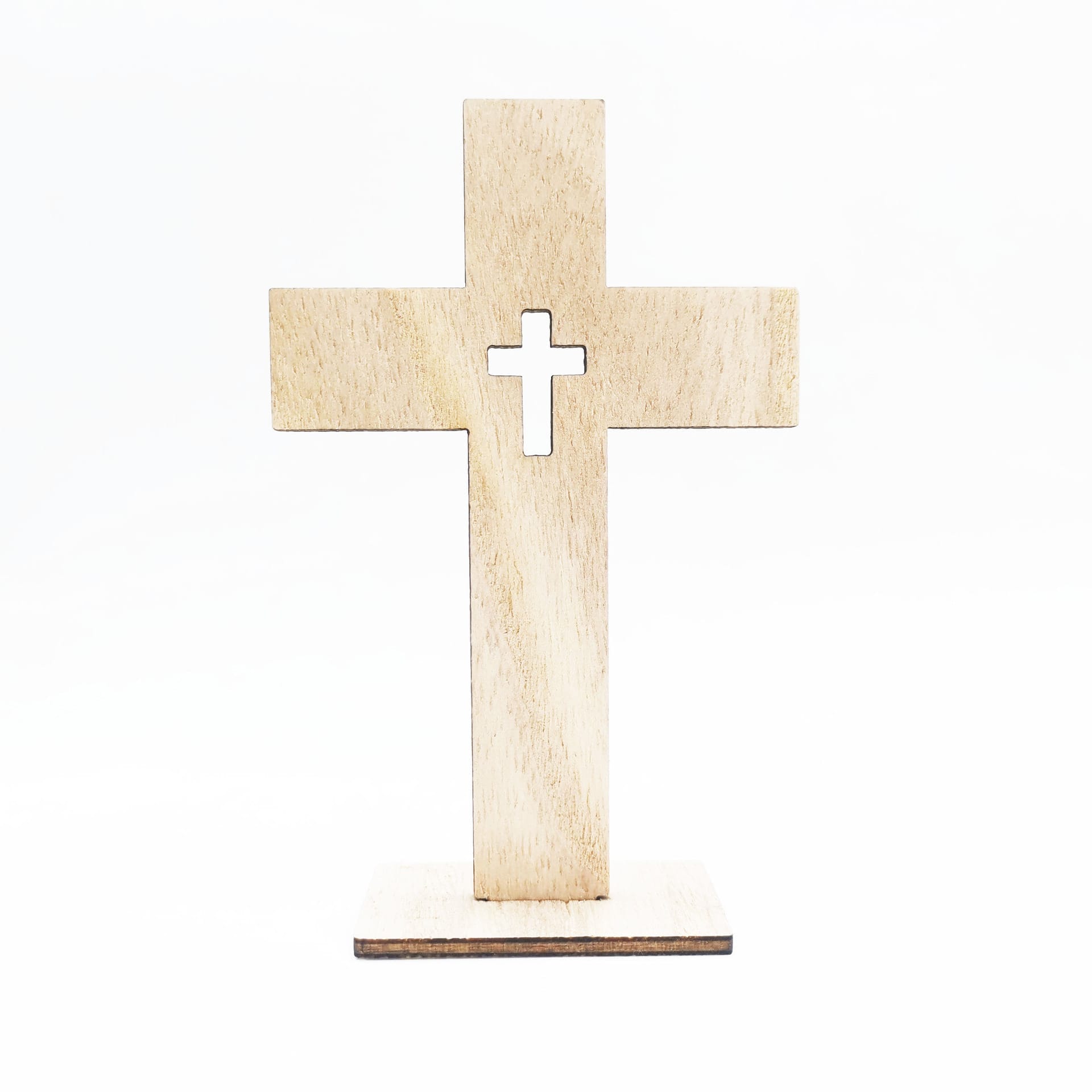 A handmade decorative wood cross with a smaller cross cutout in the center stands upright on a rectangular base against a white background, perfect for wholesale displays.