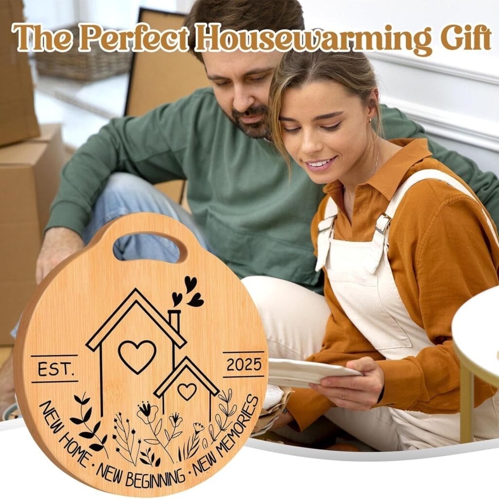 A couple sits together, looking at a card, with a wooden housewarming plaque and a wood cutting board in the foreground that read "Est. 2025, New Home, New Beginning, New Memories.