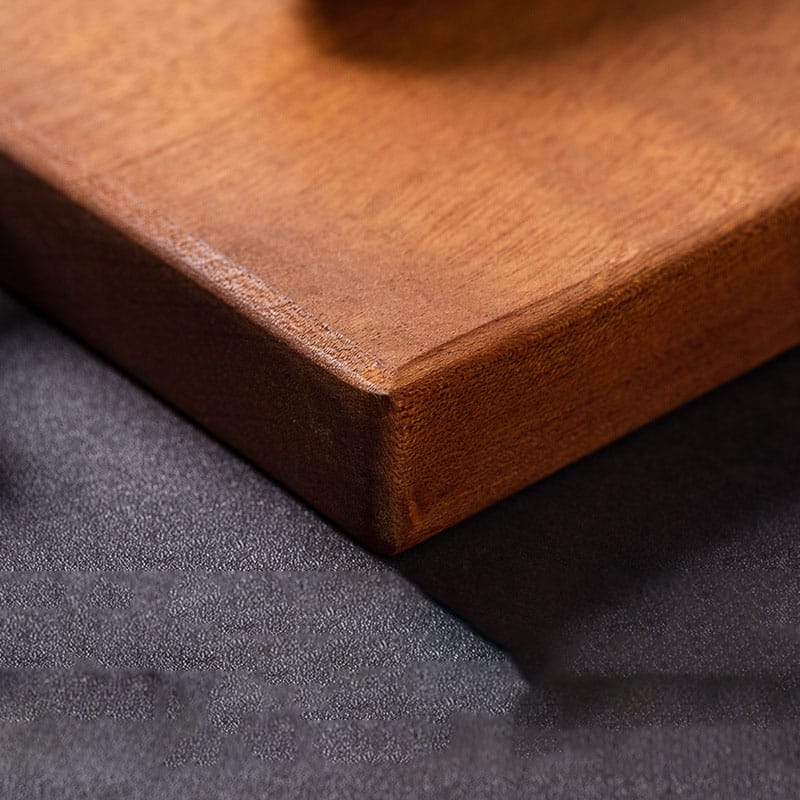 Close-up of a rich brown, solid wood cutting board. Perfect for bulk kitchen orders.