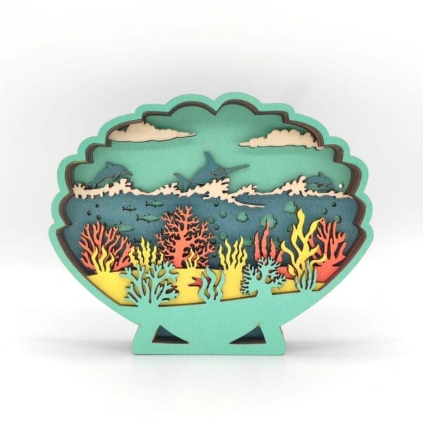 Laser-cut wooden seashell decor with dolphins and coral. Wholesale wood decor.