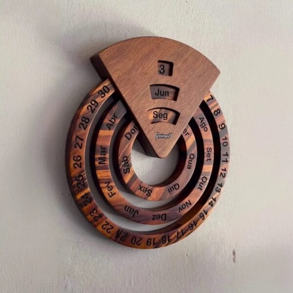 A wooden perpetual calendar with rotating rings displaying the day, month, and date adds timeless charm as a wood decoration home accent against a plain wall.