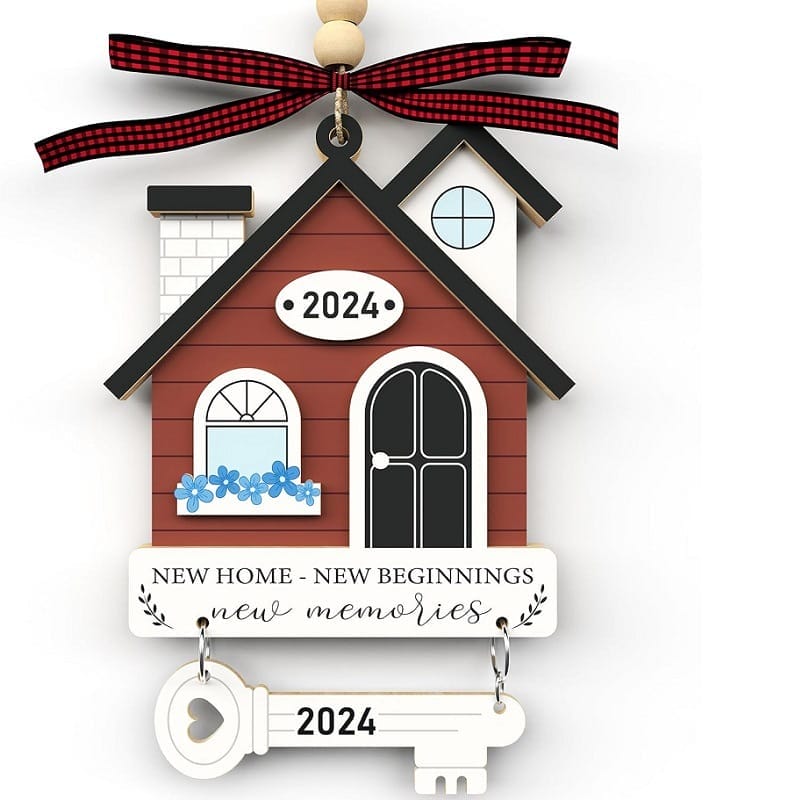 A decorative wooden Christmas ornament shaped like a house with a key, featuring the year 2024 and the text "New home - new beginnings - new memories." Perfect for wholesale orders or as a unique find from your wood gift supplier.