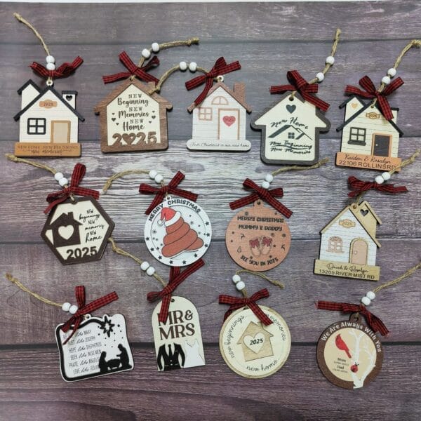 A collection of house-shaped and round Christmas Wooden Ornaments with personalized messages, red plaid bows, and twine, arranged on a wooden surface.
