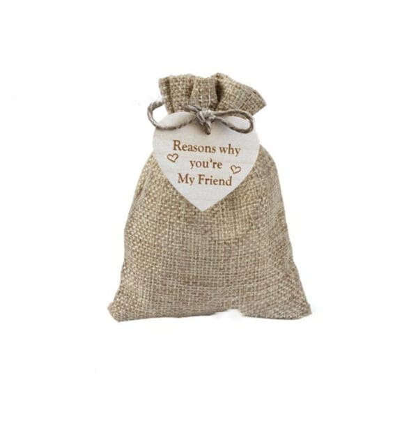 Small burlap bag with a wooden heart tag reading "Reasons why you're My Friend." Unique friendship gift.