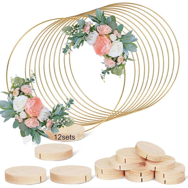 Gold metal hoops decorated with artificial flowers and greenery, paired with round wood holders featuring slits as sturdy bases, labeled as "12 sets.