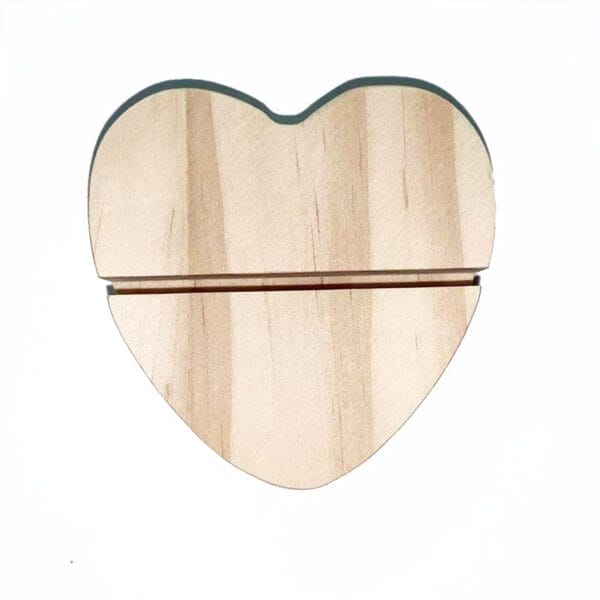 A wooden heart-shaped object with a horizontal slot near the top, perfect as wedding table decor, photographed on a white background.